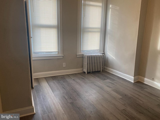 empty room with radiator and wood-type flooring