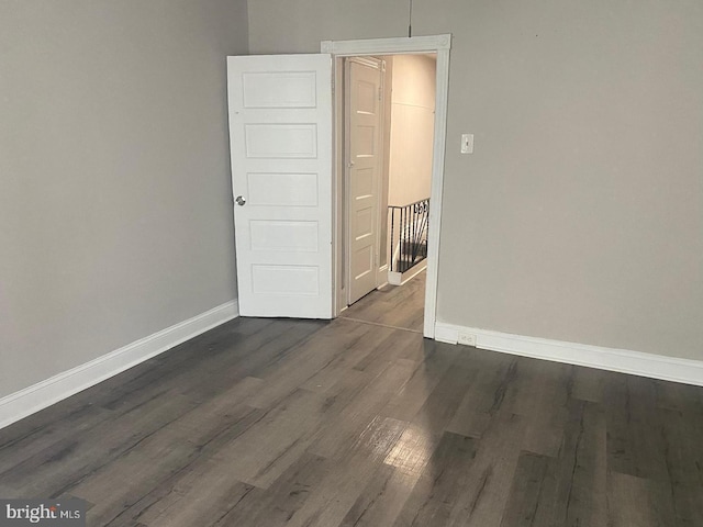 spare room featuring dark hardwood / wood-style floors