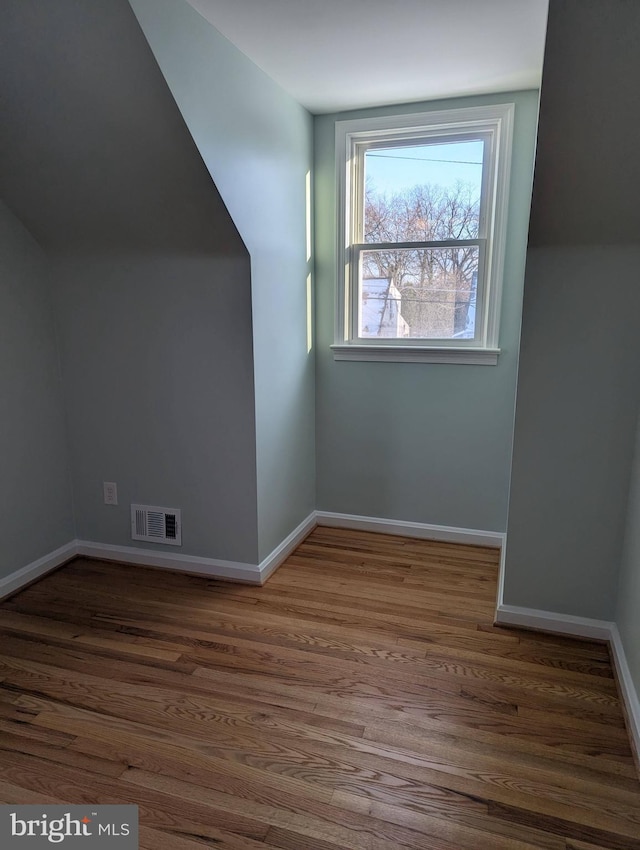 bonus room featuring dark hardwood / wood-style floors