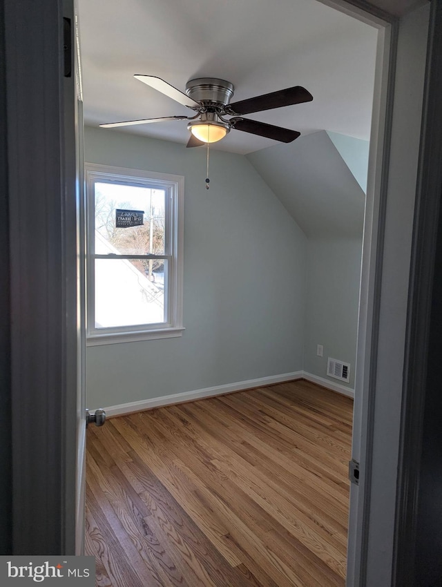 additional living space featuring light wood-type flooring, vaulted ceiling, and ceiling fan