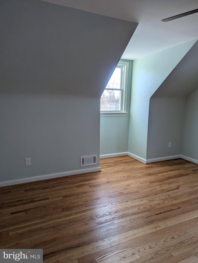 bonus room with wood-type flooring and ceiling fan