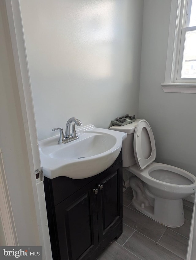 bathroom featuring toilet and vanity