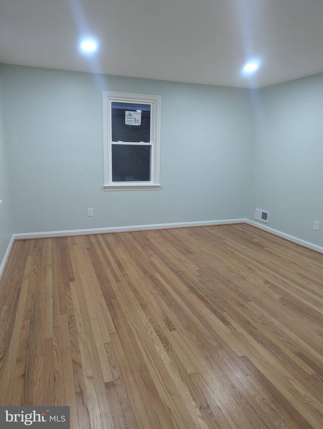 unfurnished room with light wood-type flooring