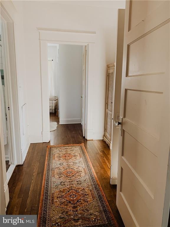 hall with dark hardwood / wood-style flooring