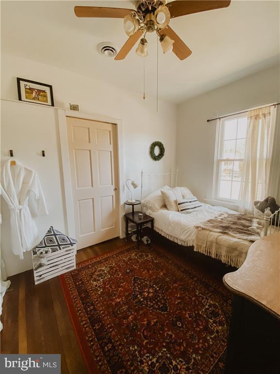 bedroom featuring ceiling fan and dark hardwood / wood-style flooring