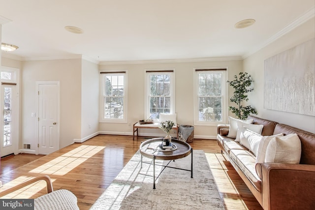 living room featuring light wood-type flooring and ornamental molding