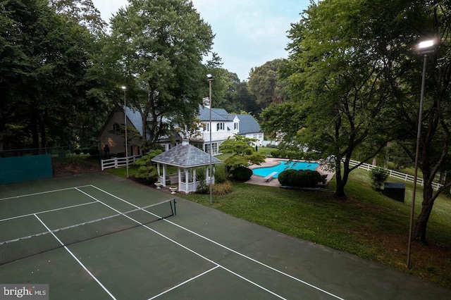 view of sport court featuring a gazebo and a yard