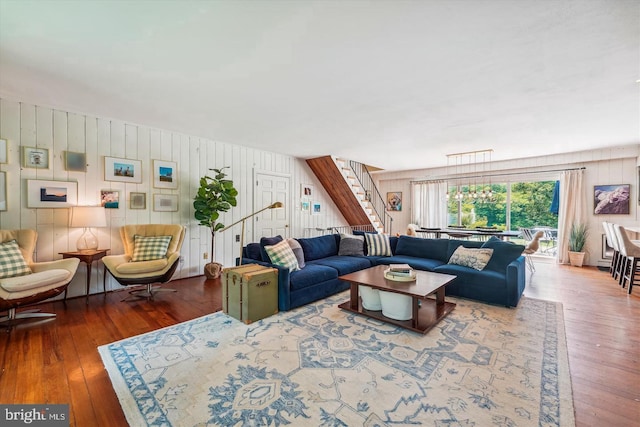 living room with wood walls and wood-type flooring