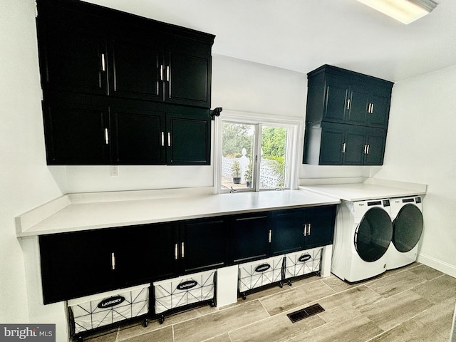 laundry area with cabinets and washing machine and dryer