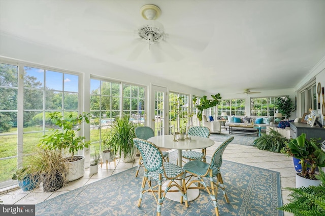 sunroom / solarium featuring ceiling fan