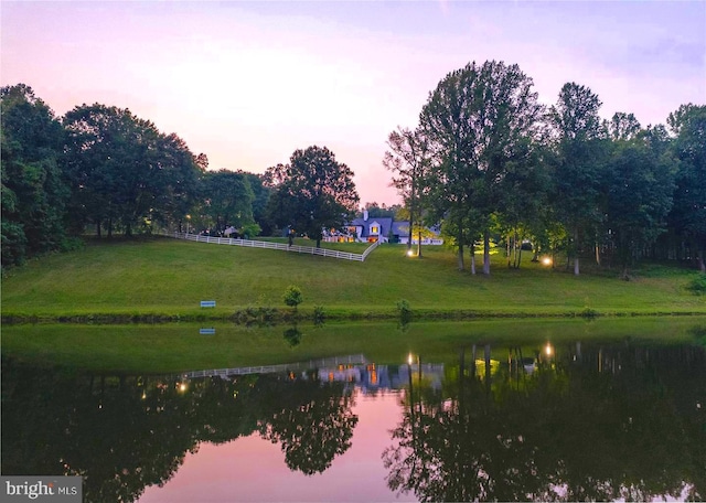 view of community with a yard and a water view