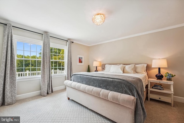 carpeted bedroom with crown molding