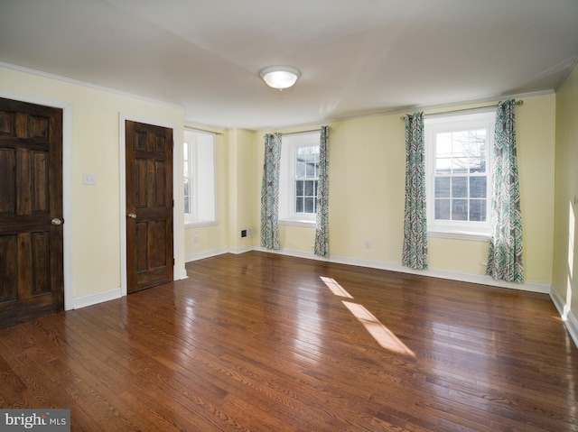 entryway with hardwood / wood-style flooring, crown molding, and plenty of natural light