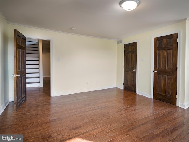 unfurnished room featuring ornamental molding and dark hardwood / wood-style floors