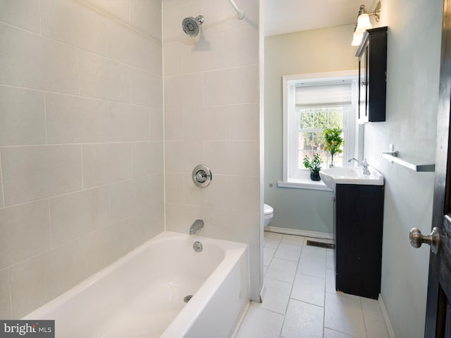 full bathroom with tile patterned floors, vanity, toilet, and tiled shower / bath combo