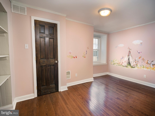 foyer with dark hardwood / wood-style flooring and ornamental molding