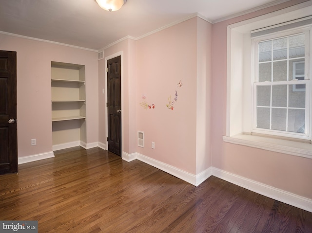 interior space with crown molding, dark wood-type flooring, and built in features