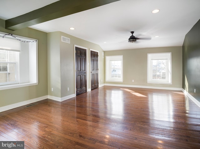 interior space featuring beamed ceiling, dark wood-type flooring, and ceiling fan