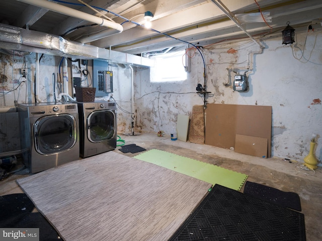 laundry room featuring washing machine and clothes dryer and electric panel