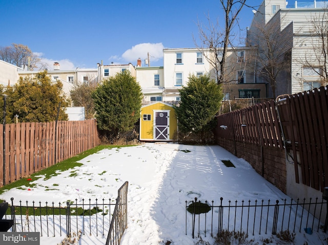 yard covered in snow with a storage unit