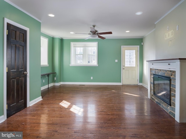 unfurnished living room featuring ornamental molding, dark wood-type flooring, ceiling fan, and a fireplace