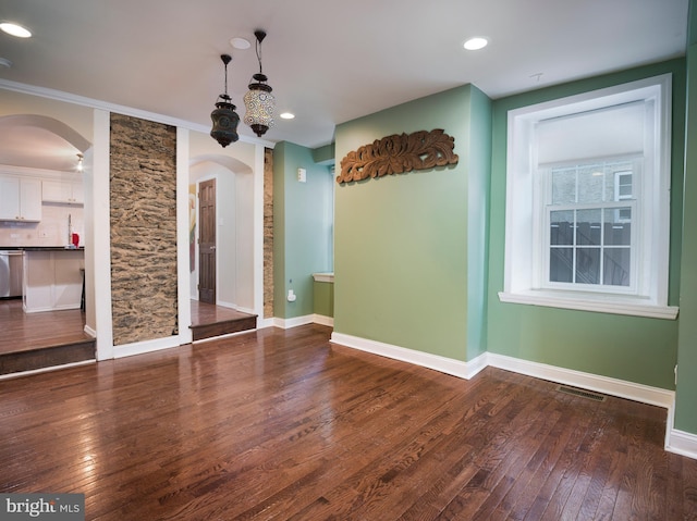 unfurnished dining area featuring wood-type flooring and ornamental molding