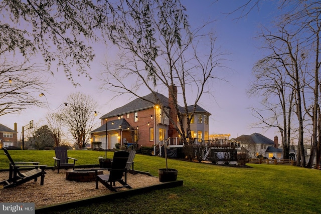 exterior space with an outdoor fire pit and a garage