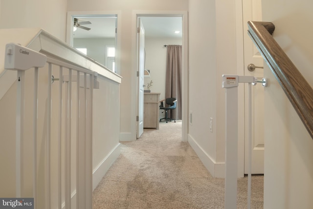 hall featuring light colored carpet