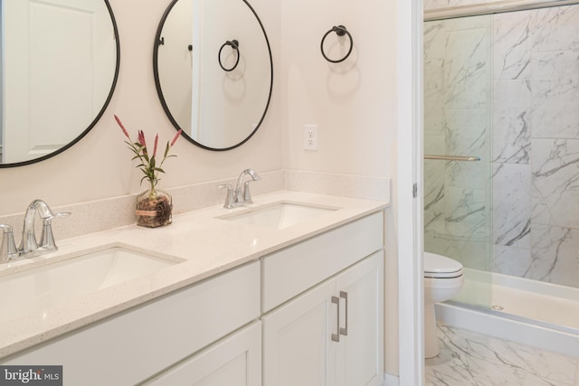 bathroom featuring vanity, toilet, and a shower with door