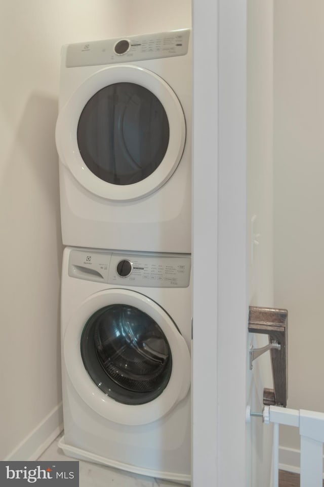 laundry area with stacked washer and clothes dryer