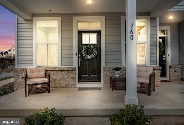 exterior entry at dusk featuring covered porch