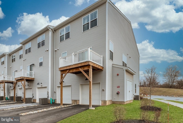 rear view of house with a balcony and central air condition unit