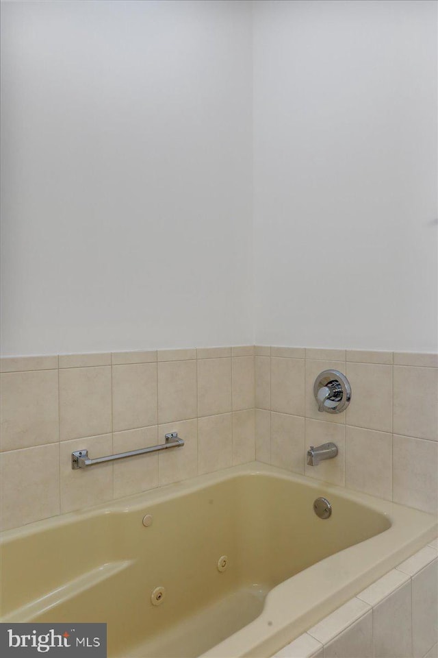 bathroom featuring a relaxing tiled tub