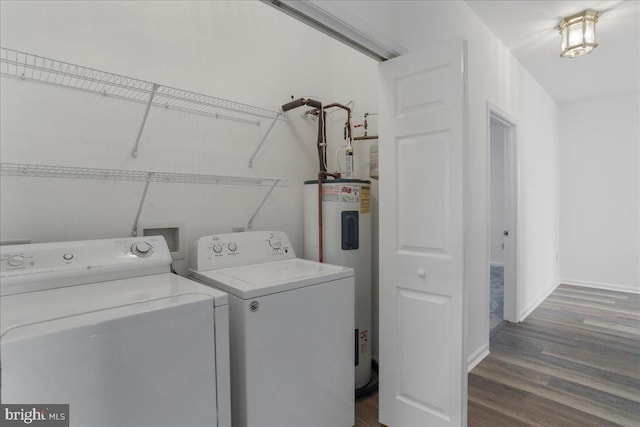 laundry room featuring dark hardwood / wood-style floors, water heater, and washing machine and clothes dryer