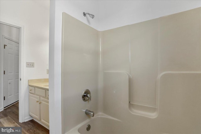 bathroom featuring vanity, tub / shower combination, and wood-type flooring