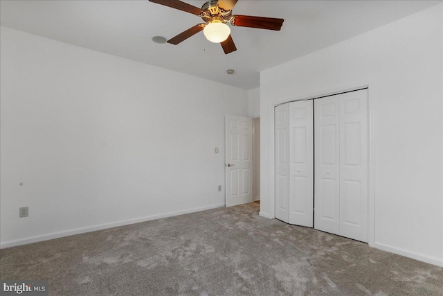 unfurnished bedroom featuring ceiling fan, carpet, and a closet