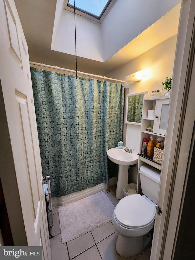 bathroom featuring toilet, tile patterned floors, and sink