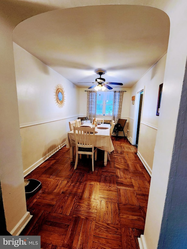 dining room with dark parquet floors and ceiling fan