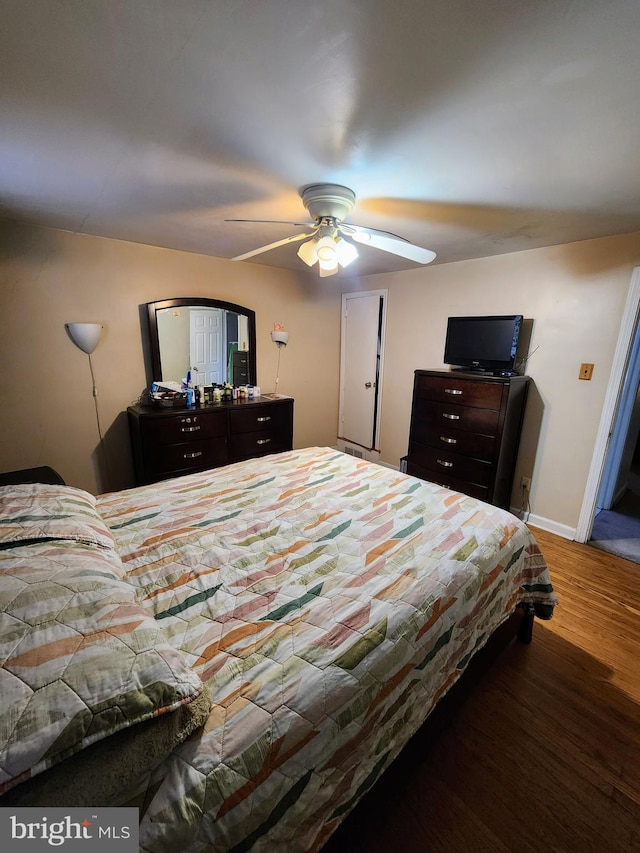 bedroom with ceiling fan and dark hardwood / wood-style floors