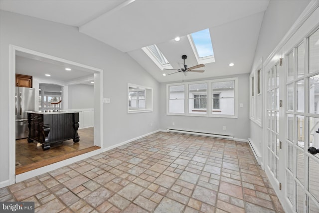 empty room featuring a baseboard heating unit, ceiling fan, and vaulted ceiling