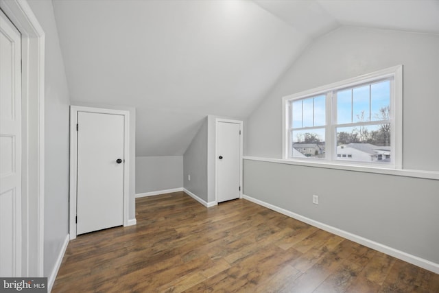 additional living space featuring dark hardwood / wood-style flooring and vaulted ceiling