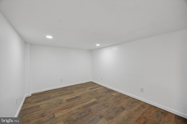 unfurnished room with dark wood-type flooring