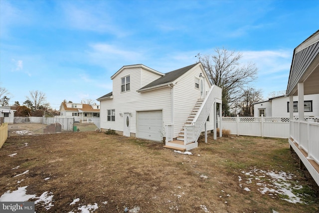 back of property with a garage