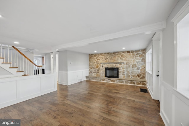 unfurnished living room with dark hardwood / wood-style flooring and a fireplace