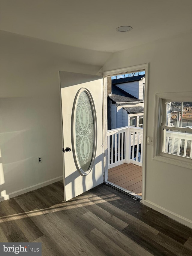 foyer entrance featuring lofted ceiling and dark hardwood / wood-style flooring