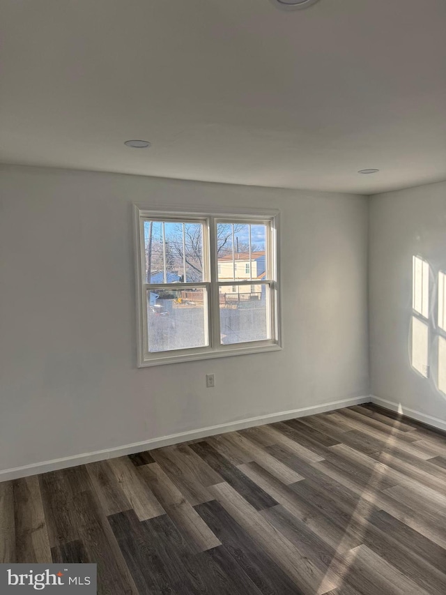 unfurnished room featuring dark hardwood / wood-style floors