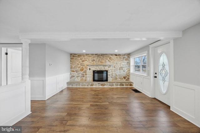 unfurnished living room featuring a fireplace and dark hardwood / wood-style floors