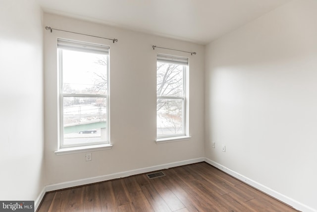 spare room featuring dark wood-type flooring