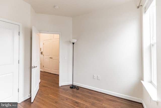 unfurnished bedroom with dark hardwood / wood-style floors