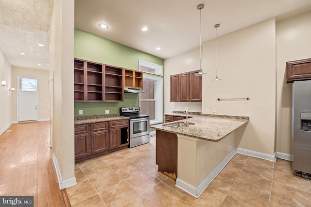 kitchen featuring kitchen peninsula, stainless steel appliances, decorative light fixtures, light stone countertops, and sink